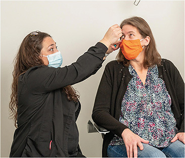 Ms. Cacciato (left) demonstrates the proper technique for drop installation.